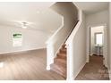 A bright staircase features carpet treads and white risers leading to the second floor at 3334 Strong Box Ln, Gastonia, NC 28052