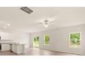 Open concept living room with kitchen, sliding glass doors to backyard, and lots of natural light at 3342 Strong Box Ln, Gastonia, NC 28052