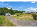 Expansive lawn leading to a large white farmhouse-style home at 355 Cal Kennedy Rd, Cleveland, NC 27013