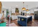 Beautiful farmhouse kitchen with a large island, pendant lights, and stainless appliances at 355 Cal Kennedy Rd, Cleveland, NC 27013