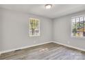 Well-lit bedroom with two windows and new flooring at 3637 Glenville Rd, Charlotte, NC 28215