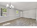 Spacious living room with large windows and newly installed floors at 3637 Glenville Rd, Charlotte, NC 28215