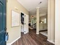 Inviting foyer with hardwood floors, modern artwork, and views to a bathroom and the living room at 4315 Poplar Grove Dr, Charlotte, NC 28269