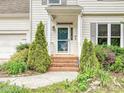 Welcoming front entrance with brick steps, lush landscaping, and a stylish glass paneled front door at 4315 Poplar Grove Dr, Charlotte, NC 28269