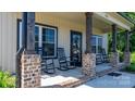 Inviting front porch featuring classic rocking chairs and brick-based support columns at 4941 Southview Dr, Hickory, NC 28602