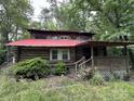 Charming log cabin exterior featuring a covered porch and a vibrant red roof at 506 Waring Ct # Lot 1, Fort Mill, SC 29707