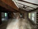 Rustic living room with log walls, high ceilings, and a unique log staircase at 506 Waring Ct # Lot 1, Fort Mill, SC 29707