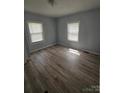 Cozy bedroom with sleek floors and dual windows providing natural light at 520 E Maple Ave, Gastonia, NC 28054