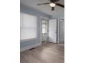 Light-filled bedroom with neutral walls, light vinyl flooring, and an open doorway at 520 E Maple Ave, Gastonia, NC 28054