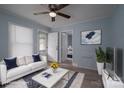 Staged living room with a comfortable sofa, stylish decor, and light vinyl flooring at 520 E Maple Ave, Gastonia, NC 28054