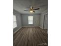 Bright living room featuring modern flooring, a ceiling fan, and ample natural light at 520 E Maple Ave, Gastonia, NC 28054