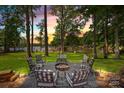 A stunning lake view enjoyed from the paved firepit area with comfortable seating at 570 Blue Heron Rd, Salisbury, NC 28146
