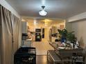 Eat in kitchen with light cabinetry, tiled floors and stainless steel appliances plus natural light from the connecting dining area at 703 S Highway 27 Hwy, Stanley, NC 28164