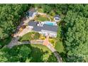 Expansive estate with lush landscaping, mature trees, sparkling pool, a detached guest house, and a circular driveway at 707 Saint Cloud Dr, Statesville, NC 28625