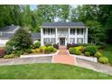 Elegant white home featuring stately columns, a second-story balcony, and professionally landscaped front yard at 707 Saint Cloud Dr, Statesville, NC 28625