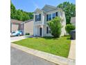 Charming two-story home with a well-manicured lawn, shutters and attached garage at 7311 Fig Ln, Charlotte, NC 28215