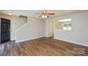 Open-concept living room featuring modern floors and neutral wall paint at 7311 Fig Ln, Charlotte, NC 28215