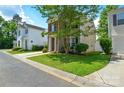 View of a well-maintained two-story home with an attached garage and green lawn at 7711 Brisbane Ct, Charlotte, NC 28215