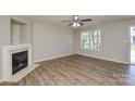 Bright living room features a fireplace, ceiling fan and lots of natural light at 7711 Brisbane Ct, Charlotte, NC 28215