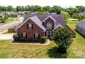 Aerial view of a brick home with a well-maintained lawn and mature landscaping at 786 Sw Treva Anne Sw Dr, Concord, NC 28027