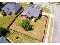 Aerial view of a fenced backyard, featuring a well-kept lawn and mature trees at 786 Sw Treva Anne Sw Dr, Concord, NC 28027