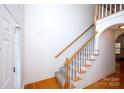 Bright entry way featuring a staircase with wooden handrail and carpeted steps, leading to the second floor at 786 Treva Anne Sw Dr, Concord, NC 28027