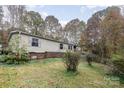 Charming single-story home surrounded by trees; features neutral siding and a cozy, inviting facade at 811 Acclaim Dr, York, SC 29745