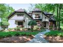 Charming two-story home with manicured lawn, lush landscaping, and a stone walkway leading to the front door at 8534 Highgrove St, Charlotte, NC 28277