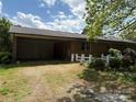 View of the brick home, and the covered carport, showing the ample parking and access to the house at 947 Ravendale Dr, Charlotte, NC 28216