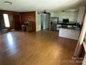 Open-concept living area featuring hardwood floors and a seamless transition to the updated kitchen at 947 Ravendale Dr, Charlotte, NC 28216