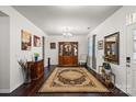 Elegant living room featuring hardwood floors, a decorative rug, and a stylish display cabinet at 9533 Silverdale Ln, Charlotte, NC 28269