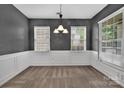 Elegant dining room features classic wainscoting, neutral paint, and ample natural light at 9614 Turning Wheel Dr, Charlotte, NC 28214