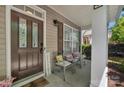 Inviting front porch with seating, a decorative door, and a 'Welcome' sign, enhancing curb appeal at 9614 Turning Wheel Dr, Charlotte, NC 28214