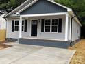 Close up shot of a home featuring gray siding, black shutters, and a covered porch at 1024 Short St, Salisbury, NC 28144