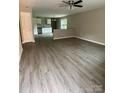 Spacious living room featuring modern wood-look floors and a ceiling fan at 1024 Short St, Salisbury, NC 28144