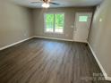 Inviting living room boasts wood-look floors, a ceiling fan, and ample natural light through a large window at 1024 Short St, Salisbury, NC 28144
