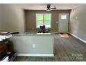 Bright living area with sleek flooring, gray walls, and a view of the outdoors through a large window at 1024 Short St, Salisbury, NC 28144