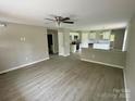 Bright, open living room flows into the kitchen with stainless steel appliances and white cabinets at 1024 Short St, Salisbury, NC 28144