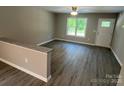 Bright living room featuring wood-look floors, ceiling fan, and a large window providing natural light at 1024 Short St, Salisbury, NC 28144