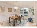 Well-lit dining room with a wooden table and decorative chandelier fixture at 1104 Snowbird Ln, Waxhaw, NC 28173