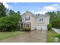 Charming two-story home featuring a well-manicured lawn, two-car garage, and inviting curb appeal at 1104 Snowbird Ln, Waxhaw, NC 28173