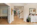 Bright foyer with hardwood floors, staircase, and views into the living spaces at 1104 Snowbird Ln, Waxhaw, NC 28173