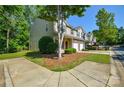 A view of the property from the sidewalk shows its townhome design with attached garages and a shared outdoor space at 1113 Geyser Ct, Fort Mill, SC 29715