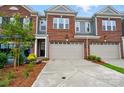 Charming townhome with a brick facade, attached garage, and well-maintained landscaping at 12051 Lavinia Ln, Charlotte, NC 28277