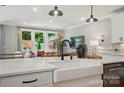 Bright kitchen island with modern faucet, farmhouse sink, and space for bar stools at 12051 Lavinia Ln, Charlotte, NC 28277