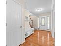 Bright foyer with hardwood floors, white trim, and a staircase leading to the upper level at 13223 Willow Breeze Ln, Huntersville, NC 28078