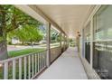 Spacious covered front porch offers great neighborhood views and natural light through windows at 13223 Willow Breeze Ln, Huntersville, NC 28078