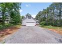 Detached garage with ample parking and a quaint front porch in a wooded setting at 1406 High Shoals Rd, Lincolnton, NC 28092