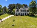 Inviting two-story home with a lush green lawn and a long driveway leading to the residence at 148 Spring Grove Dr, Mooresville, NC 28117