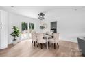 Bright dining room with a modern light fixture and sliding glass doors to a deck at 1537 Spangler Dr, Shelby, NC 28150